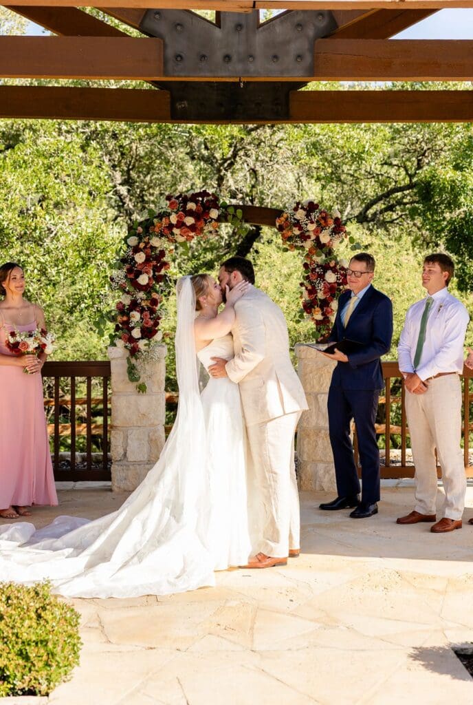 Bride and groom kissing at the altar at The Milestone Boerne