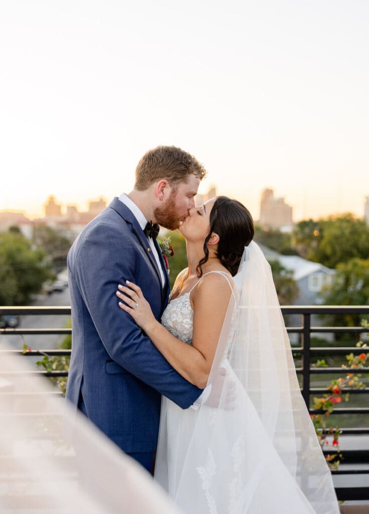 Romantic sunset portrait of bride and groom on the rooftop terrace at The Skyline San Antonio wedding venue.