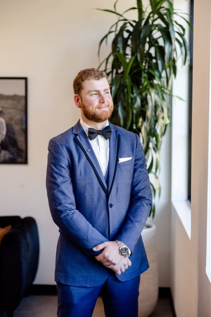 Groom individual portrait by an open window