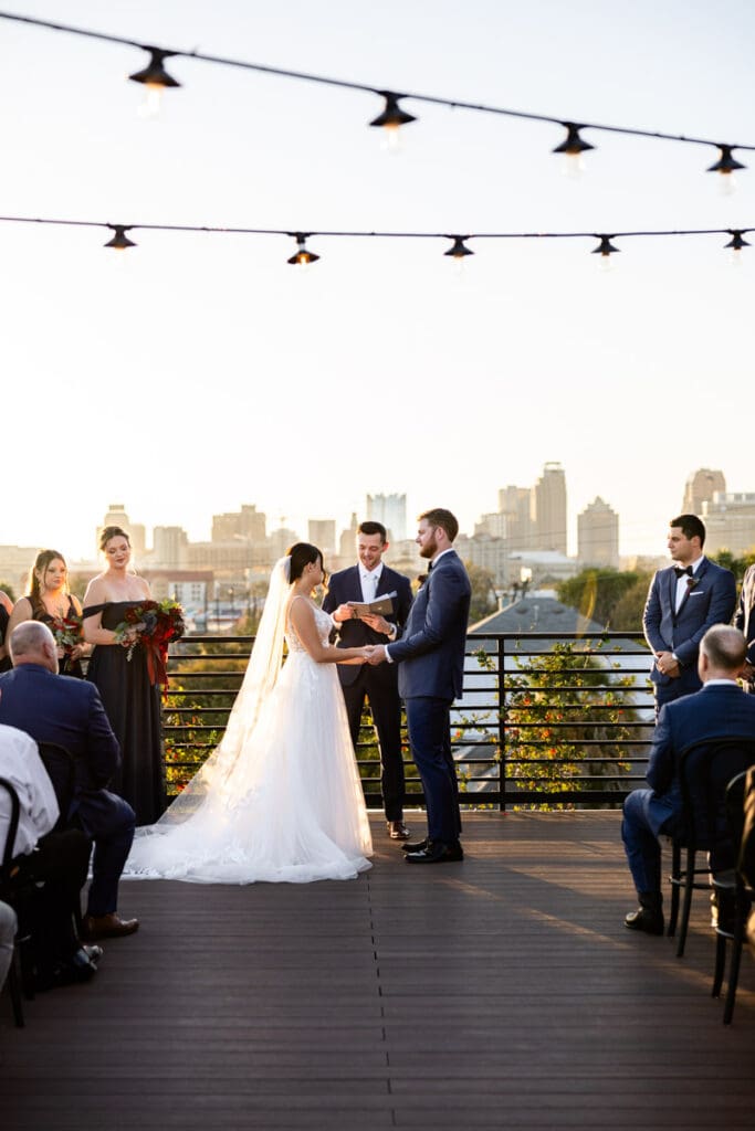Wedding ceremony on the rooftop terrace at The Skyline San Antonio with downtown San Antonio skyline views.