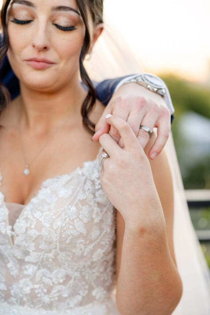 Bride holding grooms hand in a ring focus shot during bridal portraits at The Skyline San Antonio.