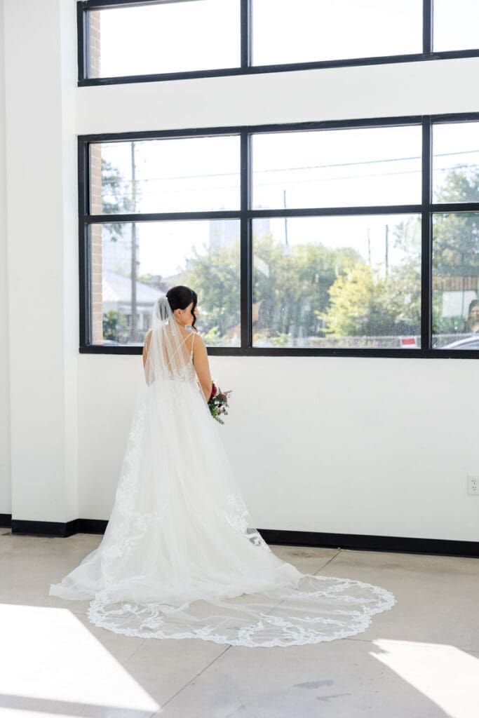 Bridal portrait in the reception hall of the skyline near a large window