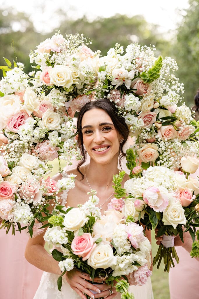 bride surrounded by bouquets