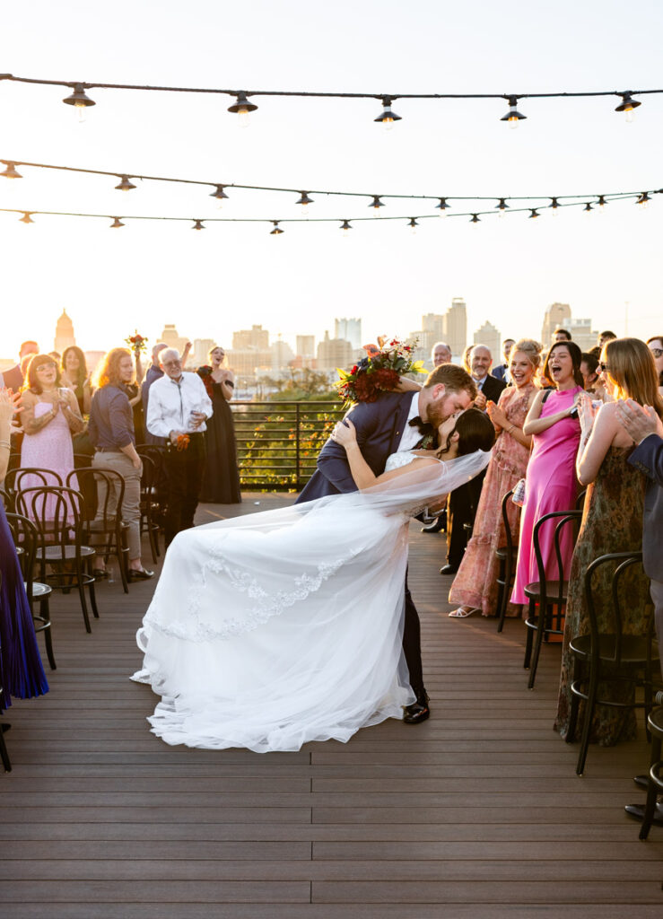wedding ceremony couple kiss and dip down the isle